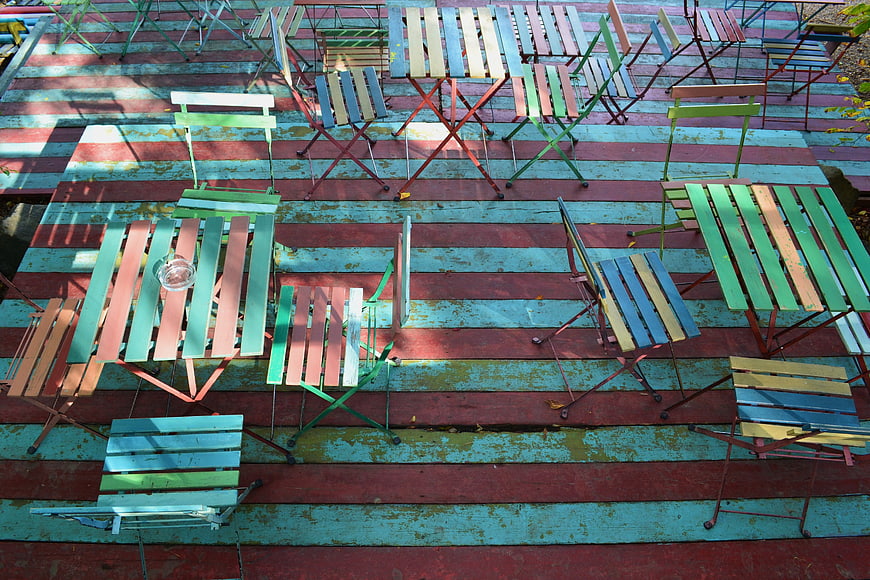 Colorful Outdoor Terrace with Wooden Tables and Chairs