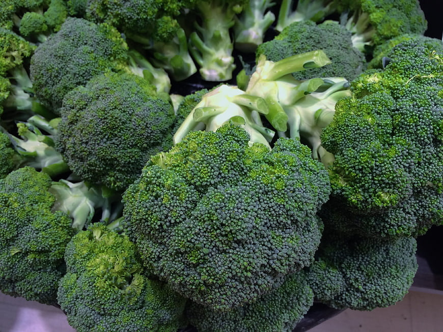 Fresh Broccoli Heads Displayed On A Supermarket Sales Floor