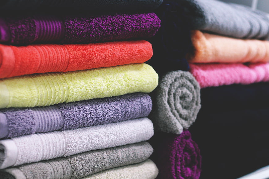 Stack of colorful folded towels in bathroom