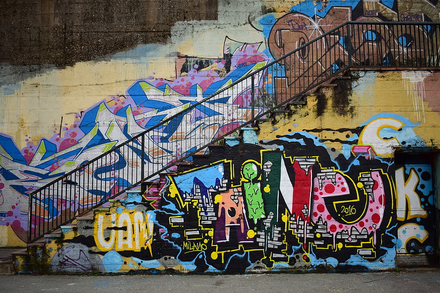 Colorful Graffiti Art on Urban Wall with Metal Staircase