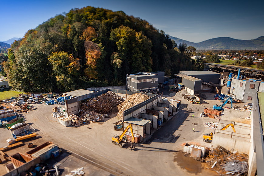 Aerial view of industrial recycling facility with machinery and scrap piles