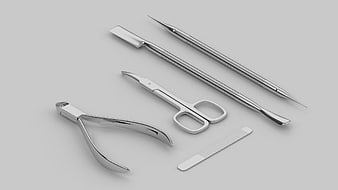 Stainless Steel Manicure Tools Arrangement On Gray Background