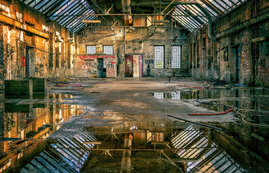 Abandoned Industrial Factory Hall With Water Reflections And Graffiti