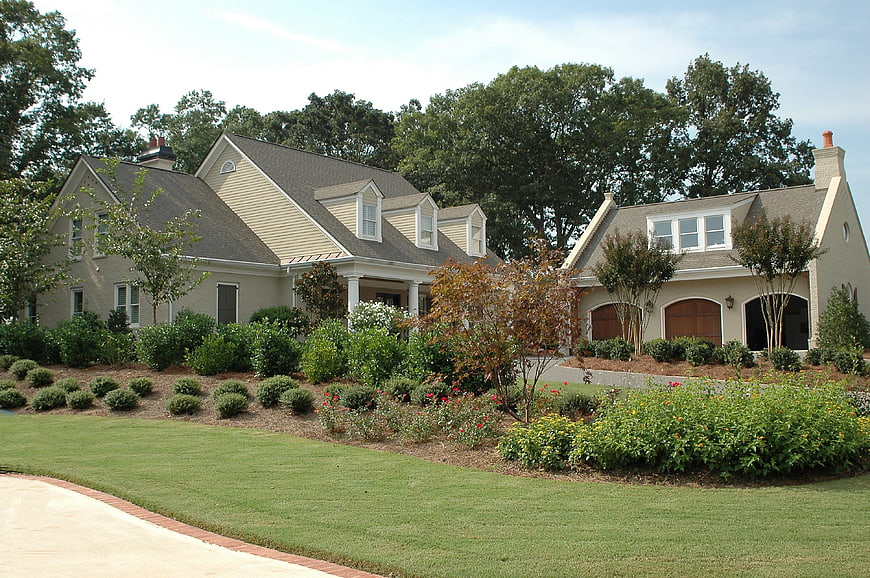 Large suburban home with manicured lawn and landscaping