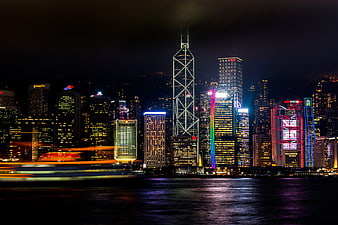 Hong Kong skyline at night with long exposure boat trails