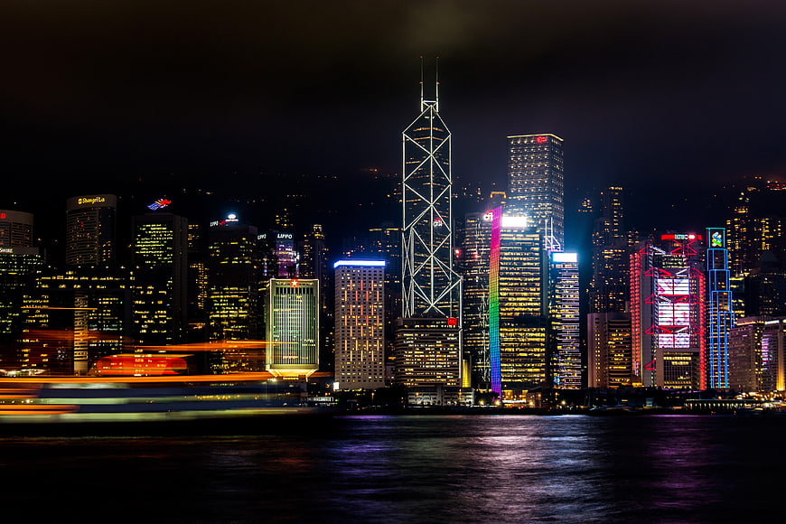 Hong Kong skyline at night with long exposure boat trails