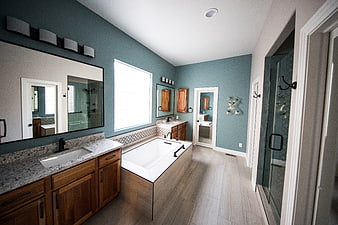 Modern Master Bathroom with Teal Walls and Double Vanity