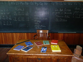 Vintage one-room schoolhouse teacher desk and blackboard