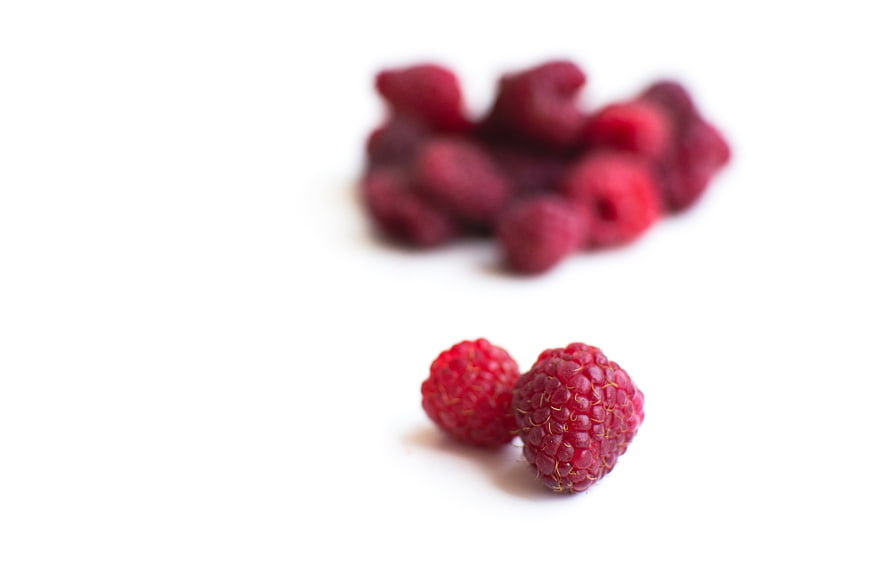 Fresh Raspberries on White Background with Copyspace