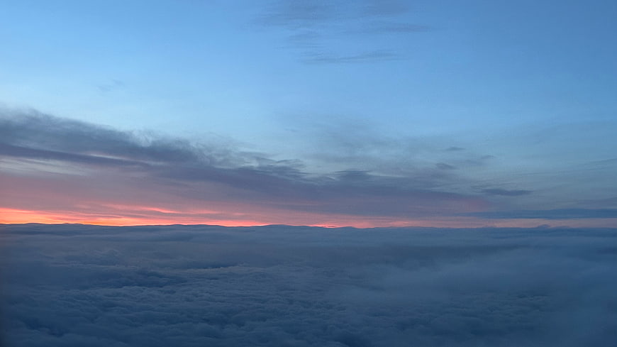 Aerial View of Sea of Clouds at Sunset with Pink Horizon