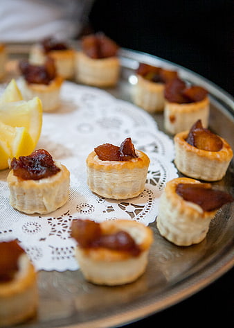 Mini savory pastry appetizers with jam filling on silver tray