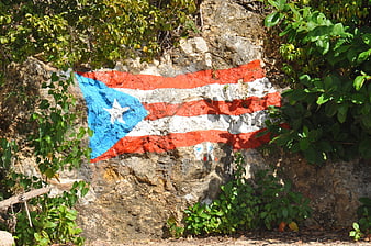 Puerto Rican flag painted on a rocky cliff face