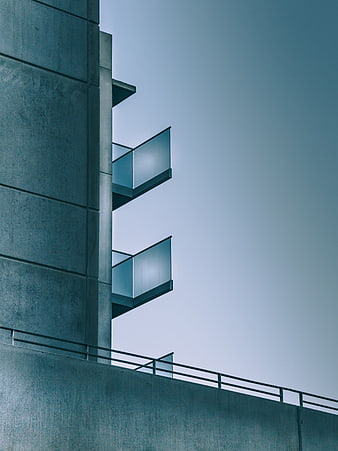 Modern Concrete Architecture with Glass Balconies Against Blue Sky