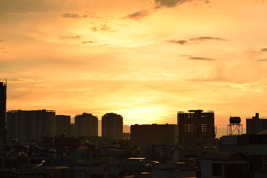 City Skyline Silhouette Against Vibrant Orange Sunset Sky