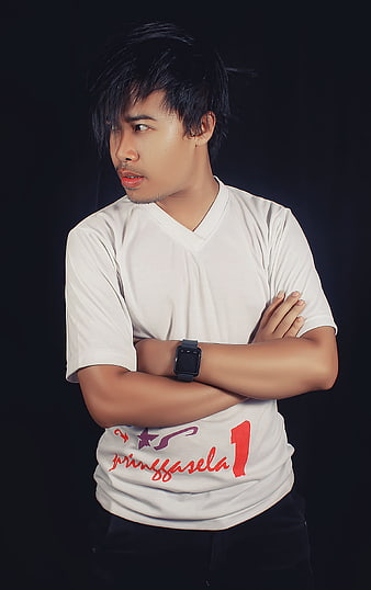 Portrait of Young Man in White T-Shirt with Crossed Arms