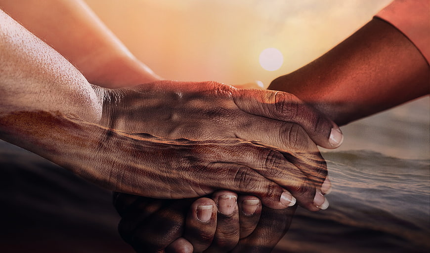 Double Exposure of Holding Hands and Ocean Sunset