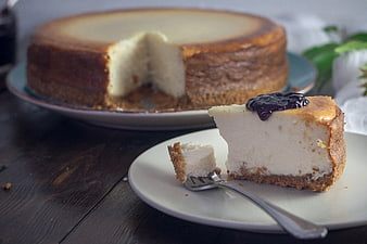 Creamy Cheesecake Slice With Dark Berry Jam On White Plate