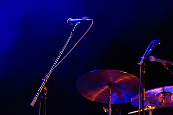 Microphones and Drum Cymbals on Dark Stage with Blue Lighting