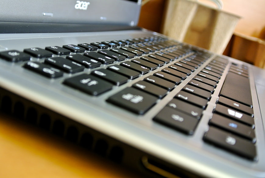 Close-up of laptop keyboard on wooden desk