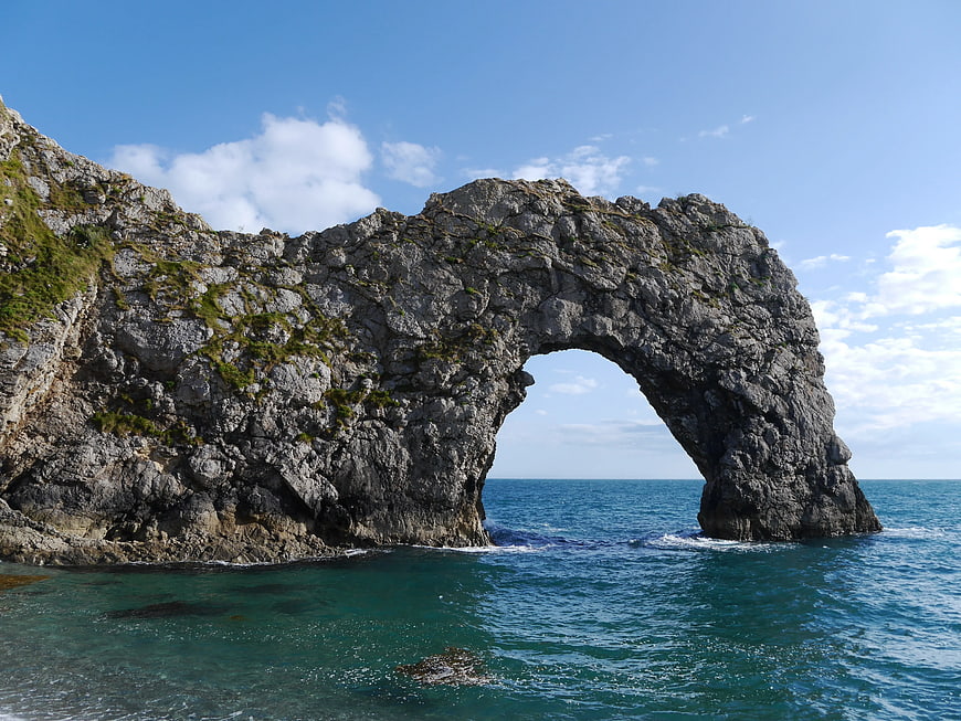 Natural Rock Arch Formation in Turquoise Ocean Water
