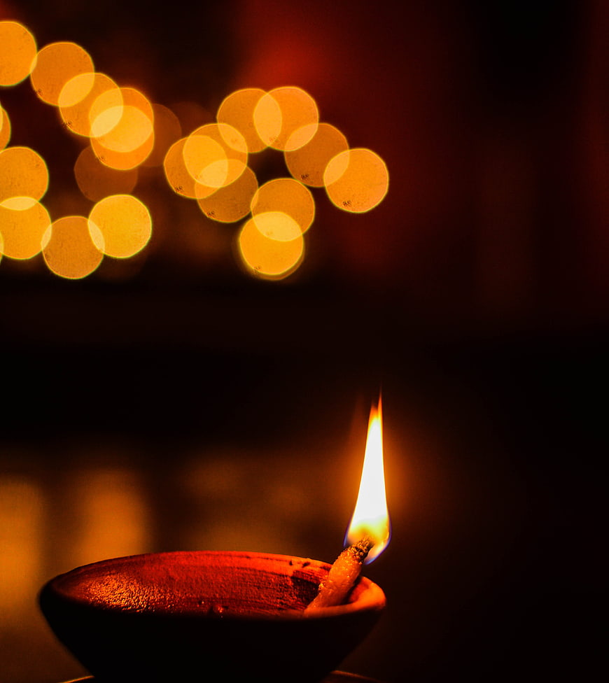 Traditional Diya Oil Lamp with Bokeh Lights for Diwali