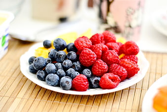 Fresh Raspberries and Blueberries on a White Plate