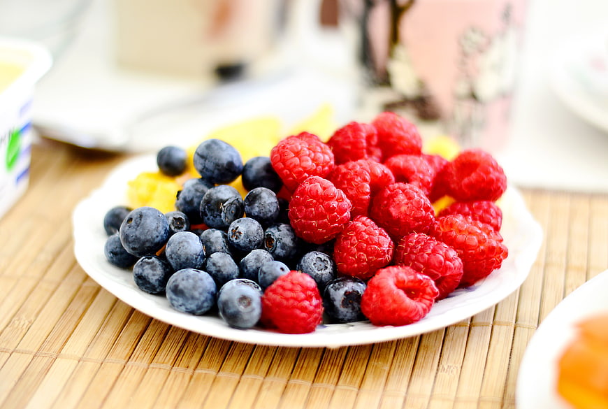 Fresh Raspberries and Blueberries on a White Plate