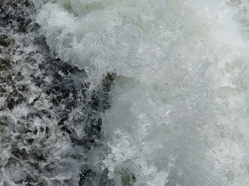 Close-up of turbulent white water rapids and foam