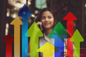 Businesswoman with colorful upward arrows overlay