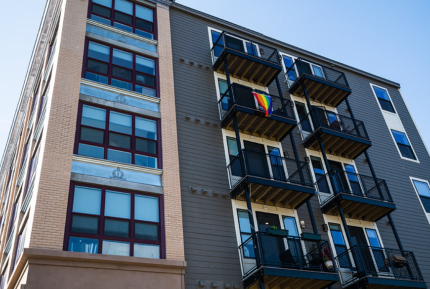 Modern Apartment Building with Rainbow Pride Flag on Balcony