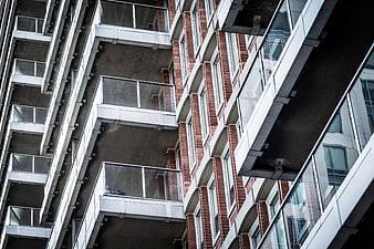 Low angle view of modern apartment building with brick and glass