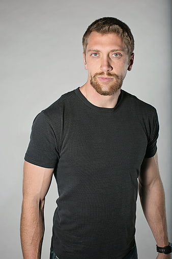 Portrait of a confident man with beard in black t-shirt