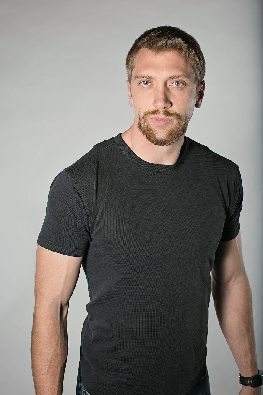Portrait of a confident man with beard in black t-shirt