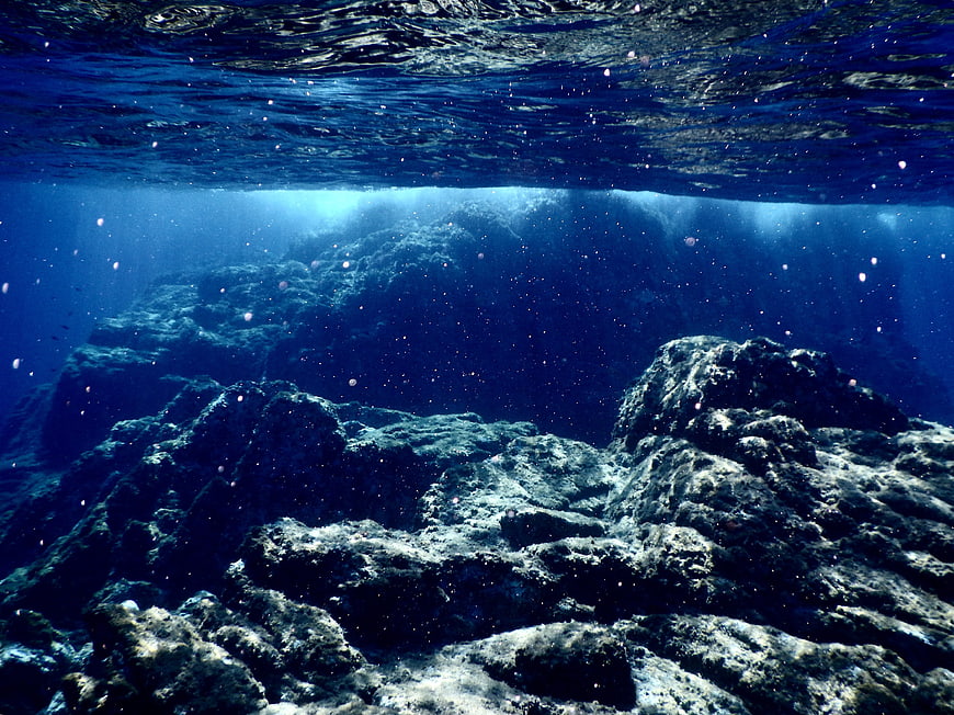Underwater Ocean Rocks with Sunbeams and Bubbles