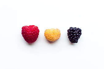 Red, Yellow, and Black Raspberries on White Background