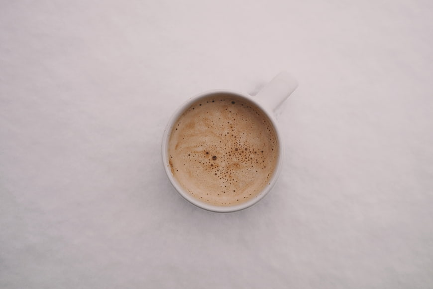 Top View of Cappuccino in White Cup on Marble