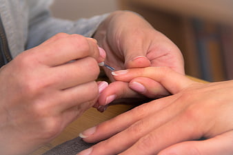 Close-up of manicure with nail polish brush
