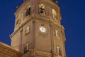Illuminated Historic Bell Tower Against Deep Blue Night Sky