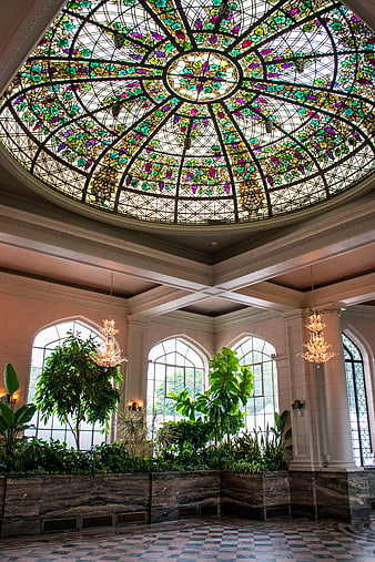 Ornate stained glass dome ceiling in a luxurious lobby