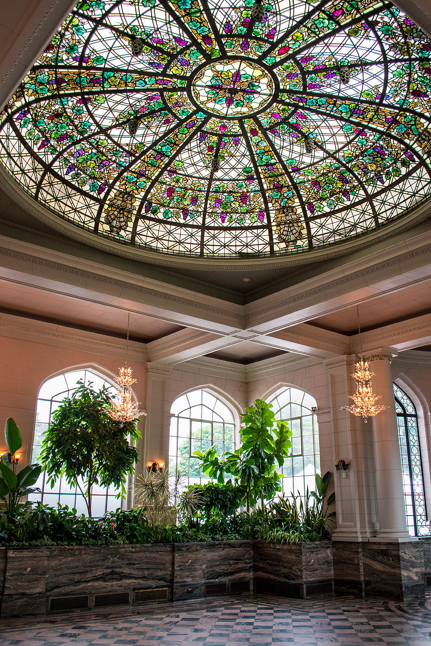 Ornate stained glass dome ceiling in a luxurious lobby