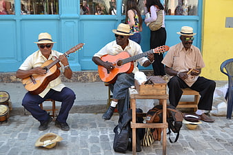 Cuban street musicians playing guitar and percussion in Havana