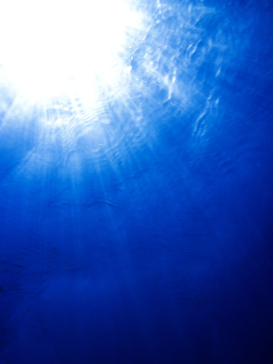 Underwater Sunlight Rays in Deep Blue Ocean Water