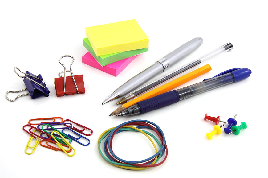 Colorful Office Supplies Arrangement On White Background