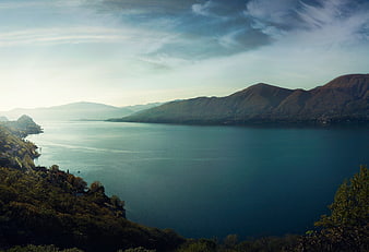 Serene Lake Landscape with Mountains and Cloudy Sky