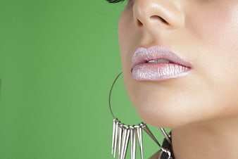 Close-up of Woman's Lips with Glittery Makeup and Silver Earrings