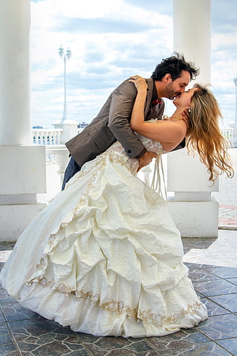 Romantic Wedding Couple Kissing on Balcony
