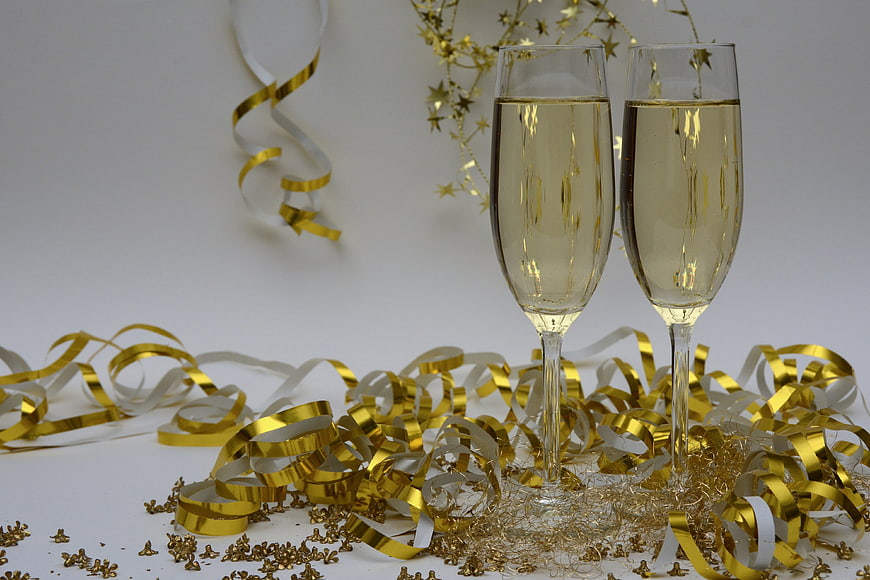 Champagne Glasses with Gold Confetti and Streamers