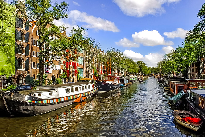 Amsterdam Canal with Houseboats and Traditional Architecture