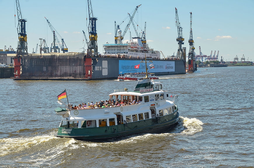 Tourist boat passing dry dock in Hamburg port