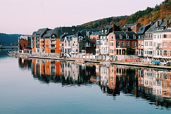 Colorful European waterfront buildings with reflections in calm river